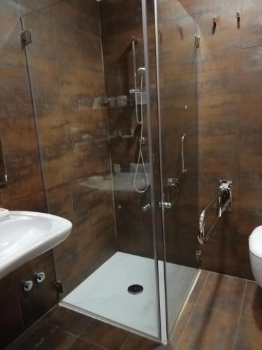 a shower with a glass door in a bathroom at Hotel Scialì in Vieste