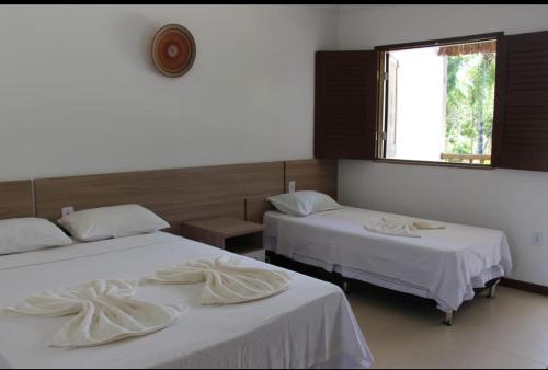 מיטה או מיטות בחדר ב-Pousada Bambui