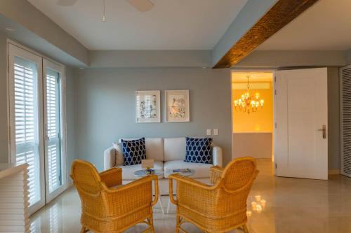 a living room with a couch and chairs and a table at Casa La Merced by Mustique in Cartagena de Indias