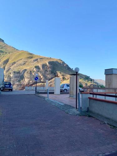 a parking lot with a mountain in the background at Little Paradise in Taormina
