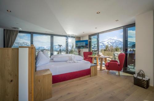 a bedroom with a bed with a view of mountains at Wellnessresort Seiwald **** Superior in Going