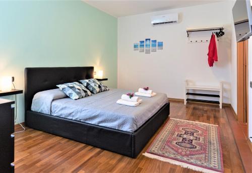 a bedroom with a bed with two towels on it at B&B Villa Apuana in Marina di Carrara