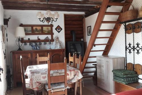 a dining room with a staircase and a table at Le chalet de Roanne-Coo in Stoumont