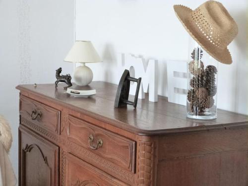 a wooden dresser with a lamp and a hat on it at Ancienne Fermette le Charlemont Givet Foisches in Foisches