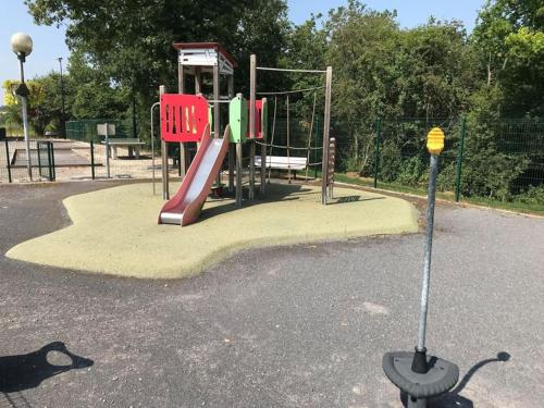 a playground in a park with a slide at Ancienne Fermette le Charlemont Givet Foisches in Foisches