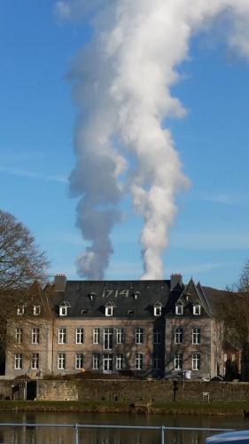 an old building with smoke coming out of it at Ancienne Fermette le Charlemont Givet Foisches in Foisches