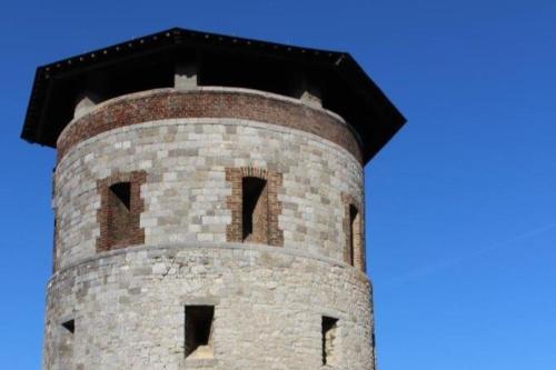 a tall brick tower with a blue sky in the background at Ancienne Fermette le Charlemont Givet Foisches in Foisches