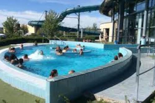 a group of people in a swimming pool at Ancienne Fermette le Charlemont Givet Foisches in Foisches