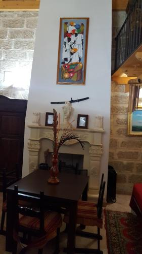 a dining room with a table and a painting on the wall at Il Castello te Lu Sannà in Merine