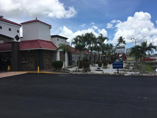 a building with a sign in front of a street at Days Inn by Wyndham Fort Myers in Fort Myers