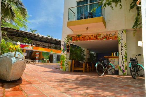 a building with a bike parked outside of it at The Cantamar Beach Hostel in Santa Marta