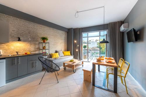 a kitchen and living room with a couch and a table at Boutique Studios & Apartments - by Avelink in Spáta