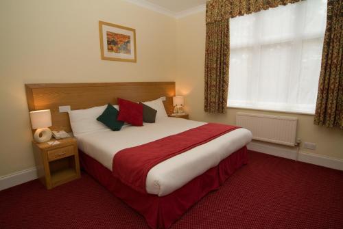 A bed or beds in a room at Dial House Hotel