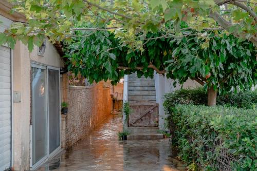 a rain soaked alley with a door in a house at Helios Residence in Spáta