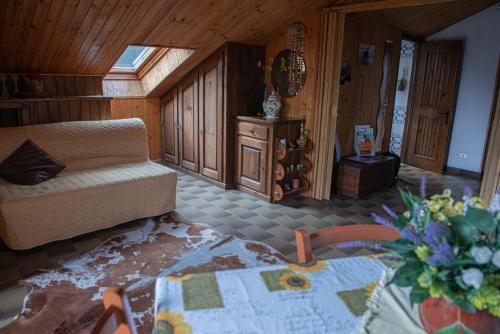 a living room with a couch and a table at Mansardato In Lurisia in Lurisia