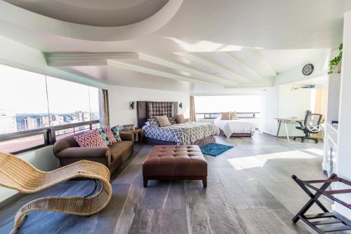 a large living room with a bed and a couch at Air Lux in Mexico City