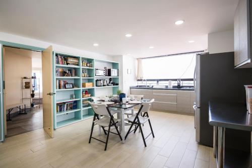a kitchen with a table and chairs in a room at Air Lux in Mexico City