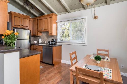 a kitchen with wooden cabinets and a wooden table at Spacious, Soaring Ceilings, Near Downtown MV, GOOG in Mountain View