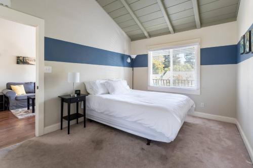 a bedroom with a bed with blue and white stripes at Spacious, Soaring Ceilings, Near Downtown MV, GOOG in Mountain View