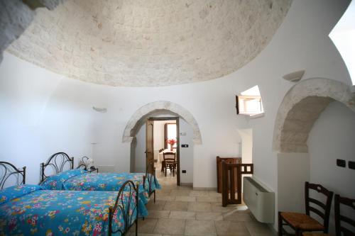 Postel nebo postele na pokoji v ubytování Trulli Convertini