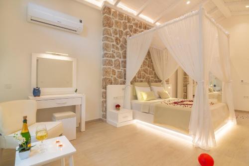a bedroom with a bed with a mosquito net at Suite La Mer in Kalkan