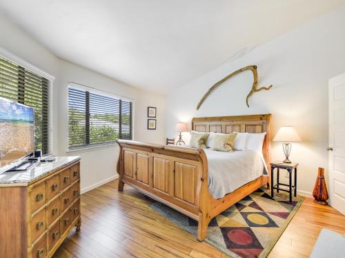 a bedroom with a large bed and a window at Lakefront Treehouse on Lake Travis Pool & Hot Tub in Lakeway
