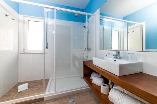 a bathroom with a sink and a shower at AZUL in Zambujeira do Mar