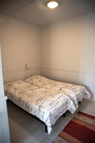 a bedroom with a bed with a white comforter at Aparthotel YlläStar in Äkäslompolo