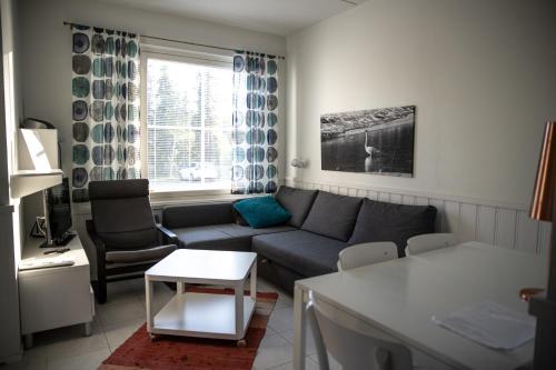 a living room with a couch and a table at Aparthotel YlläStar in Äkäslompolo