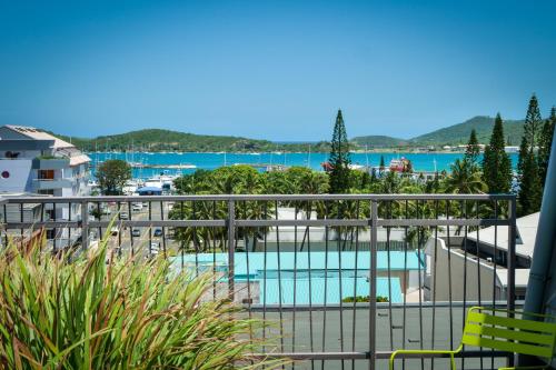 a balcony with a view of a swimming pool at Gondwana City Green in Noumea