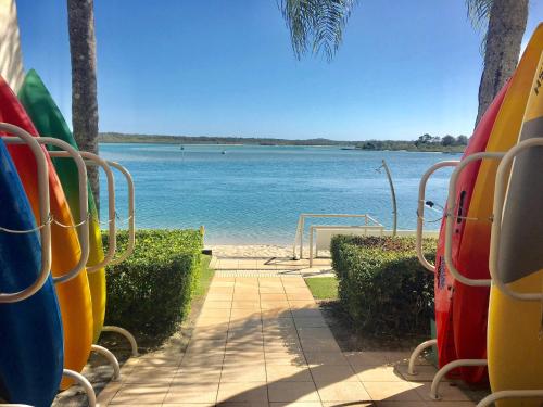 a view of the water from a beach with surfboards at Noosa Luxury Apartment in Noosa Heads