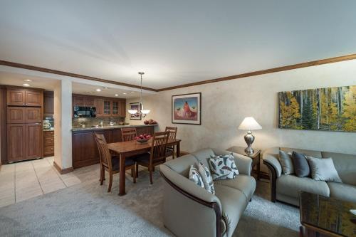 a living room with two couches and a table at Vail's Mountain Haus at the Covered Bridge in Vail