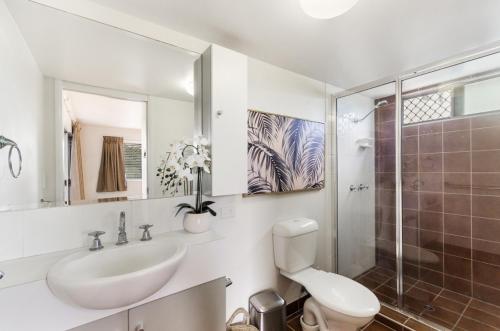 a bathroom with a sink and a toilet and a shower at City Stadium Apartment on the riverfront in Townsville