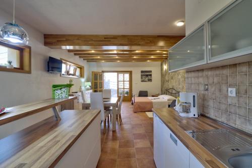 a kitchen and living room with a table and a couch at Apartments Stipe in Lukovo