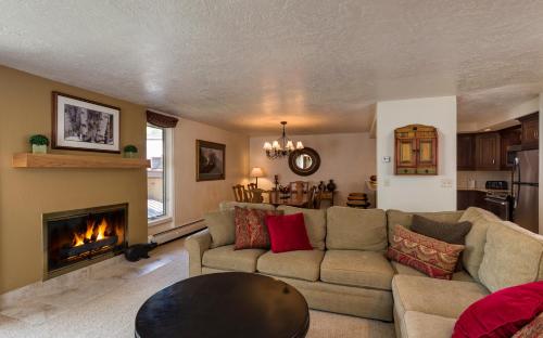 a living room with a couch and a fireplace at Vail's Mountain Haus at the Covered Bridge in Vail