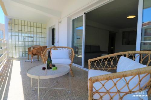 a balcony with chairs and a table and a couch at APARTBEACH DIANA Vistas Playa y Climatizado in Salou