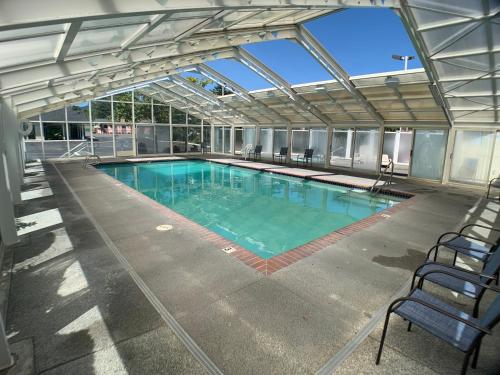 a large swimming pool in a building at Brookings Inn Resort in Brookings