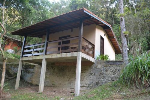 a house with a balcony on the side of it at Pousada Moinho Azul in Teresópolis