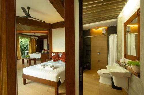 una camera con letto, servizi igienici e lavandino di West 35 Eco Mountain Resort a Balamban