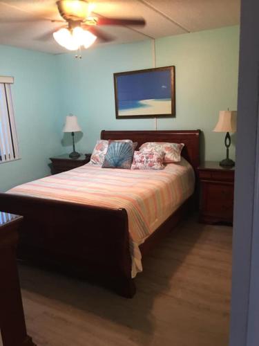 a bedroom with a bed with two pillows and a ceiling at St. Augustine Ocean & Racquet Resort in St. Augustine