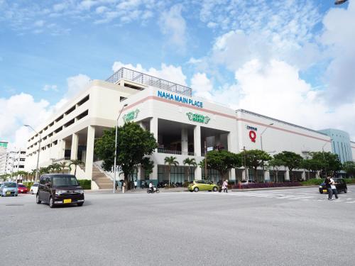 a large white building on a city street at Holiday Homes TSUBOYA 1st in Naha
