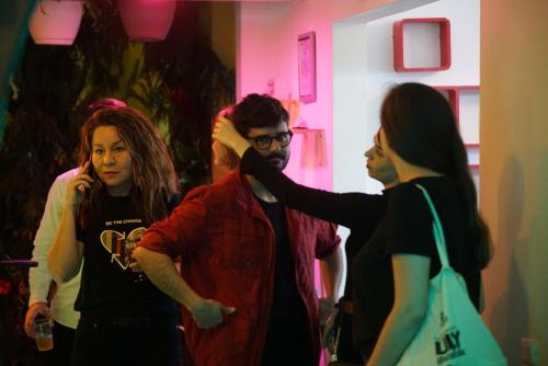 a group of people standing in a room at NATIVUS Art-Hostel in San José