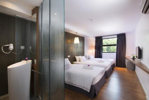 Postel nebo postele na pokoji v ubytování T+ Hotel Butterworth