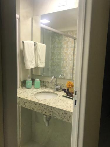 a bathroom counter with a sink and a mirror at Pipa Flat Top Ocean Residence in Pipa