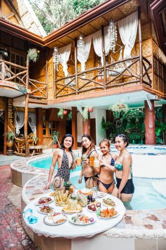a group of women in bathing suits standing around a table with food at Natura Vista in Panglao