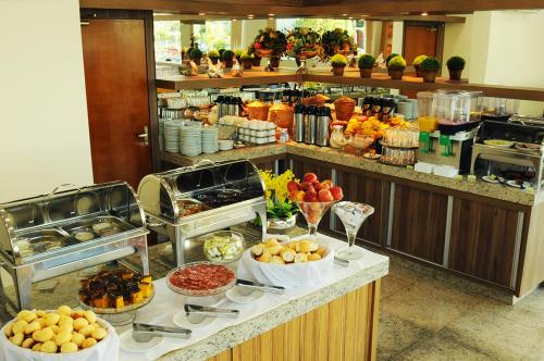 a buffet line with fruits and vegetables in a restaurant at Savana Hotel in Uberlândia