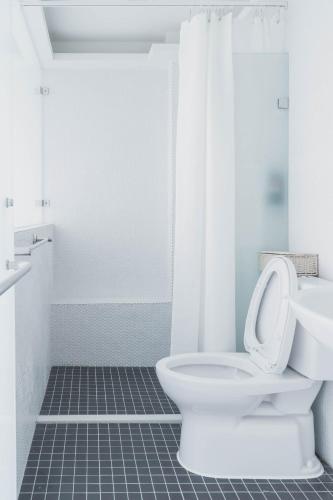 a bathroom with a toilet and a sink at Boléro Homestay I 鄰近花園夜市 in Tainan