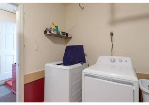 a laundry room with a washer and a washer at Home away from Home! in Deltona