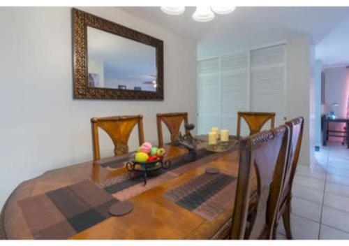 a dining room table with chairs and a mirror at Home away from Home! in Deltona