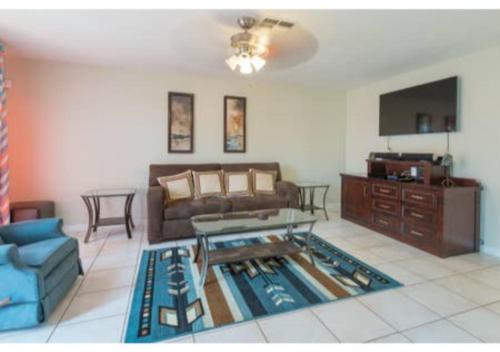 a living room with a couch and a table at Home away from Home! in Deltona